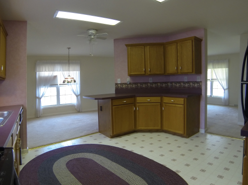 kitchen, dining area and living room from the laundry room door